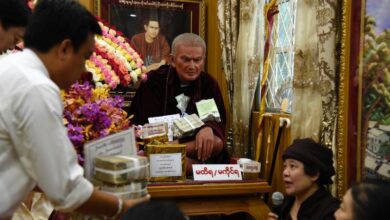 Worshippers shower a Buddhist nun with stacks of Myanmar kyat notes and U.S. dollars at a spirit event on September 9 in Thingangyun Township in Rangoon. (Photo: Thet Htoo/Myanmar Now)