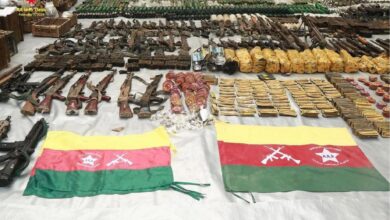 Weapons and ammunition that the AA says it seized from a junta outpost on the Myanmar-Bangladesh border on February 6, along with the flag of an ethnic Rohingya armed group (Arakan Army)