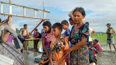 People flee from a village after renewed fighting between Myanmar’s military and the Arakan Army in November 2023 (AFP)