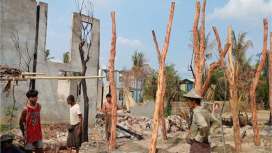 Civilians rebuild temporary homes near a building destroyed by fighting between the Myanmar military and the Arakan Army (AA) in a village in Minbya Township, Rakhine State in May 2024. (Photo: AFP)
