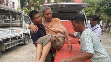 An injured person is carried to a stretcher as rescuers search for survivors in damaged government staff housing buildings following an earthquake in Naypyitaw, Myanmar on March 28, 2025 ( EPA-EFE/Nyein Chan Naing)