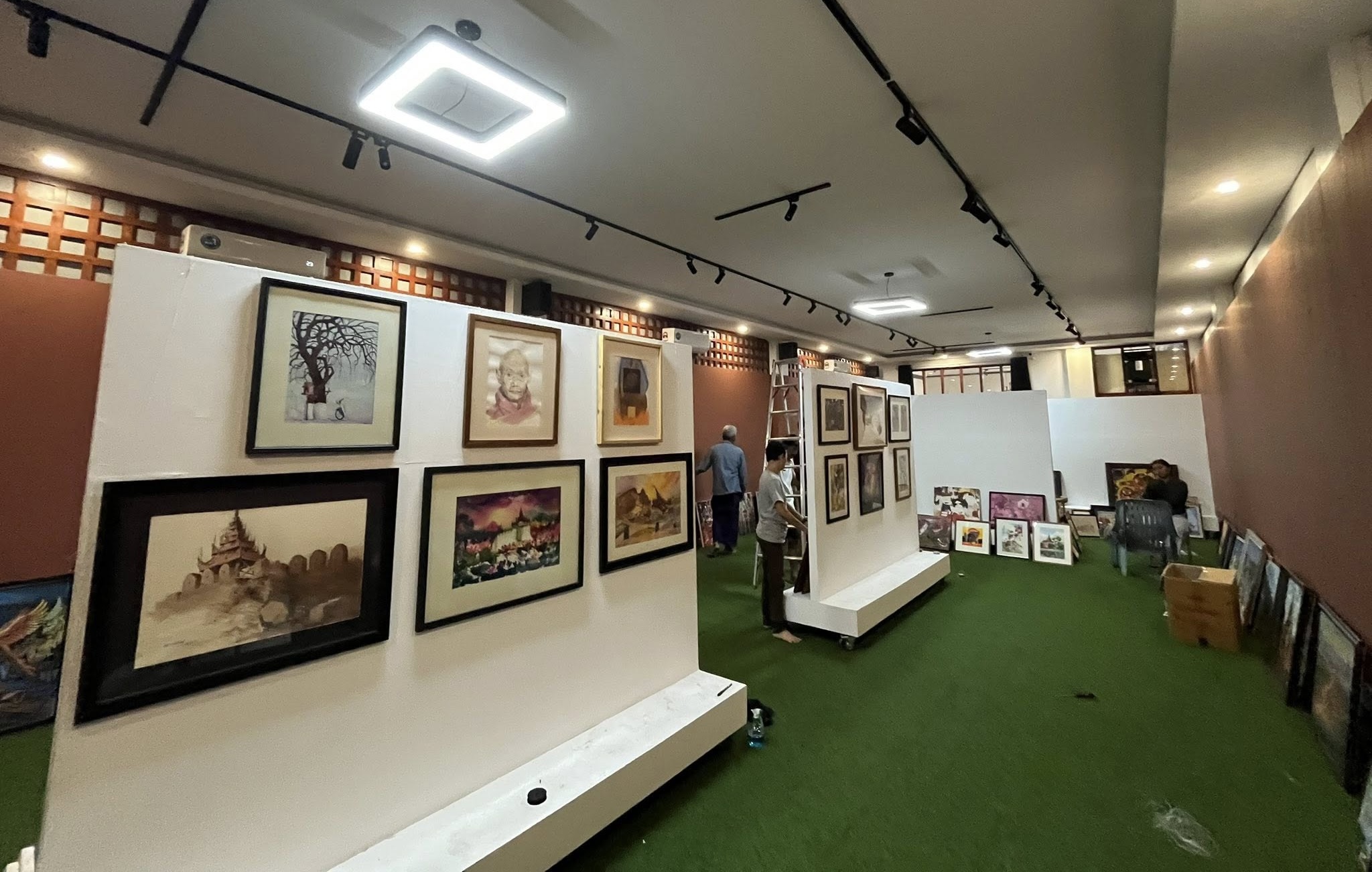 Artwork being hung and prepared for the “Phoenix Mandalay” exhibition on May 21 (Photo: Nanmati Art Gallery)