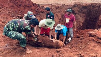 Karenni resistance fighters and others uncover an unexploded bomb dropped by the Myanmar junta’s air force in their village in Karenni State’s Demoso Township in March 2022 (Photo: KNDF)
