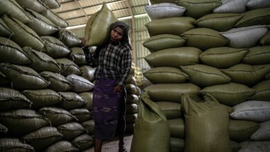 This photo, taken on May 8, 2025, shows a worker carrying a sack of rice into a warehouse in Zalun township in Myanmar's Ayeyarwady delta region. (Photo: AFP)