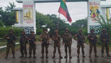 Junta troops pose outside the gate marking the entrance to Hsipaw (Photo: Pro-junta Telegram channels)