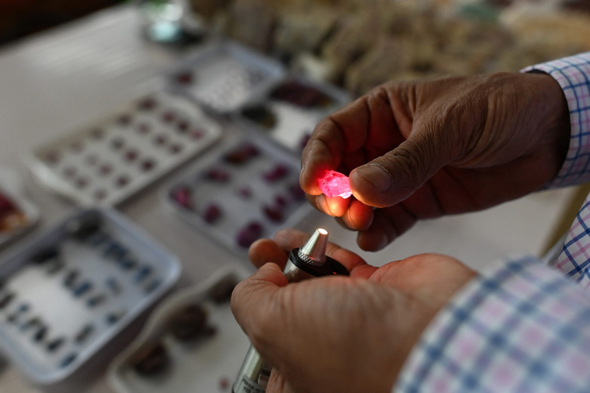 A buyer looks at a ruby at the Mogok gem market on May 17, 2019 (Photo: AFP)