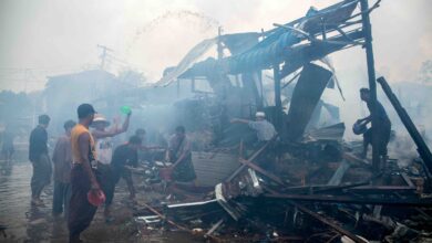 People extinguish a fire in a building that was destroyed in a bombardment carried out by Myanmar's military in Thabeikkyin Township in Mandalay Region on April 19, 2025. (Photo: AFP)