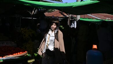 A woman walks through a market in Taunggyi, the largest town in southern Shan State, on October 31, 2025. (Photo: AFP)