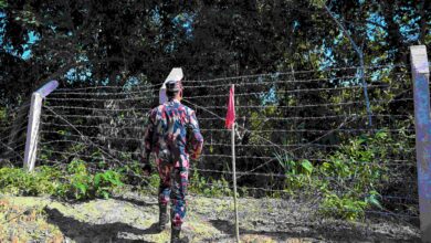 A Border Guard Bangladesh (BGB) member inspecting a red-flagged zone deemed vulnerable to landmines and restricted to prevent illegal crossings in the Bangladesh-Myanmar frontier district of Bandarban