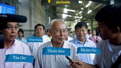 Thein Swe speaks to a reporter at the airport in Yangon following his release from prison in October 2014. He is flanked by former MI officers Tin Oo and Myint Oo, both co-directors of Delta-X Solutions. Former MI officer and Myanmar Times publisher Maj. Than Naing is behind Thein Swe. (Photo: AFP)