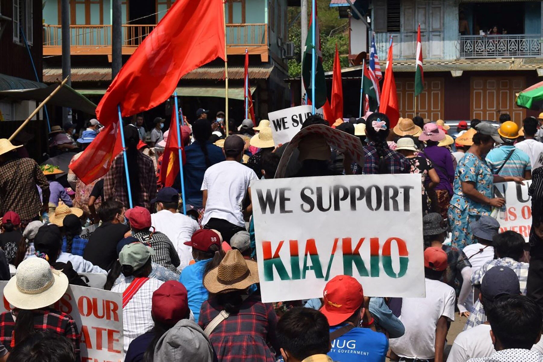A protester holds a placard supporting the Kachin Independence Organisation (KIO) and its armed wing, the Kachin Independence Army (KIA), during an anti-coup protest in Hpakant, Kachin State in May 2021 (Photo: AFP)