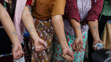 Prisoners display ink stamps on their arms authorising their release from Yangon’s Insein Prison on March 2 (Photo: Kan Kaung / Myanmar Now)