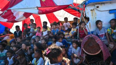 Children are seen on a boat holding Rohingya refugees as it anchors off the coast of Indonesia’s southern Aceh Province on October 22, 2024 (Photo: Chaideer Mahyuddin / AFP)