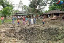 Residents of Kyet Mauk Taung stand around a crater created by a junta airstrike on the village on July 1 (Photo: One Nation News)