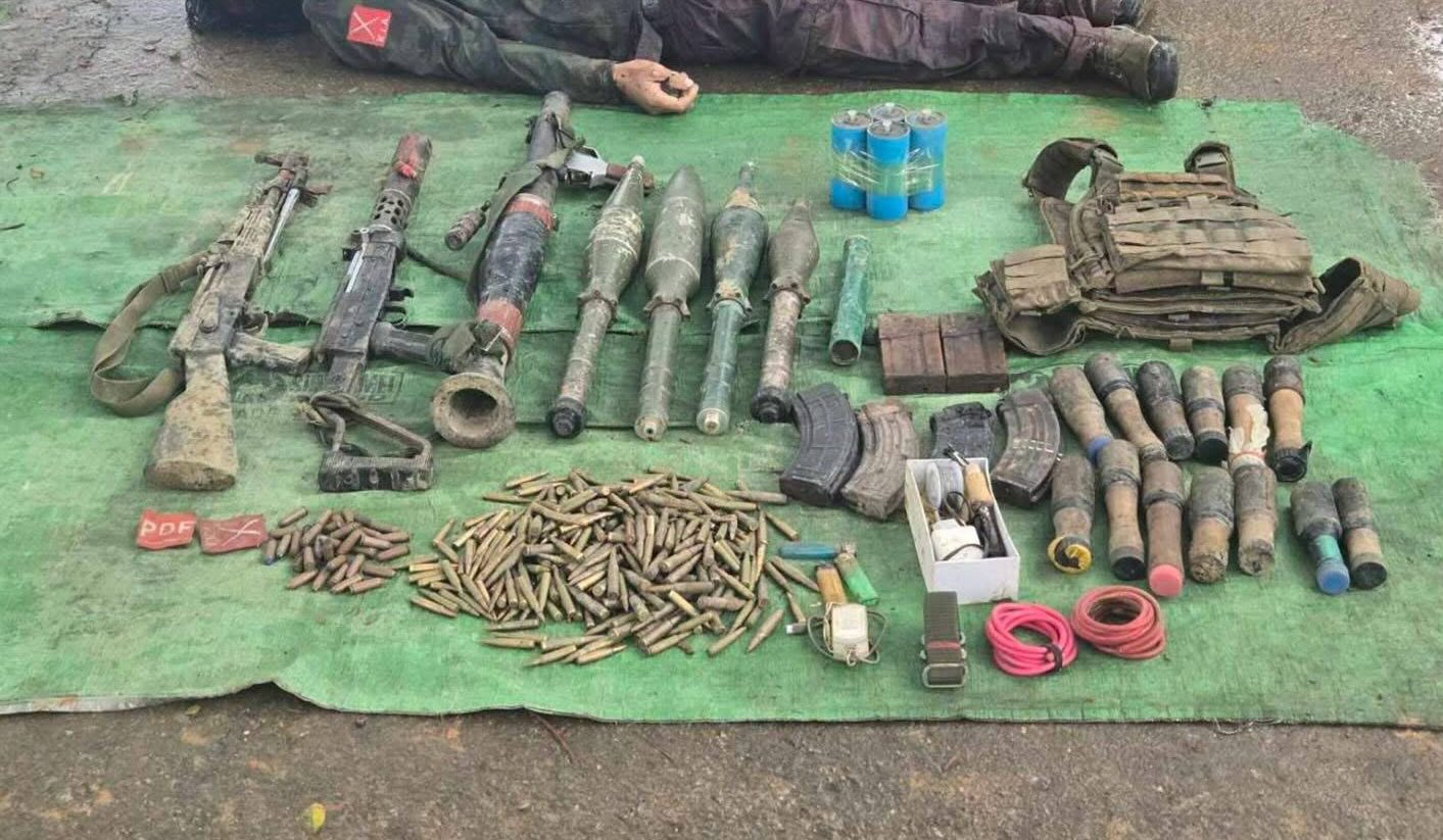 A body and some weapons and ammunition seized by junta forces from a recaptured outpost near Long Ton on July 3 (Photo: Pro-regime social media channels)
