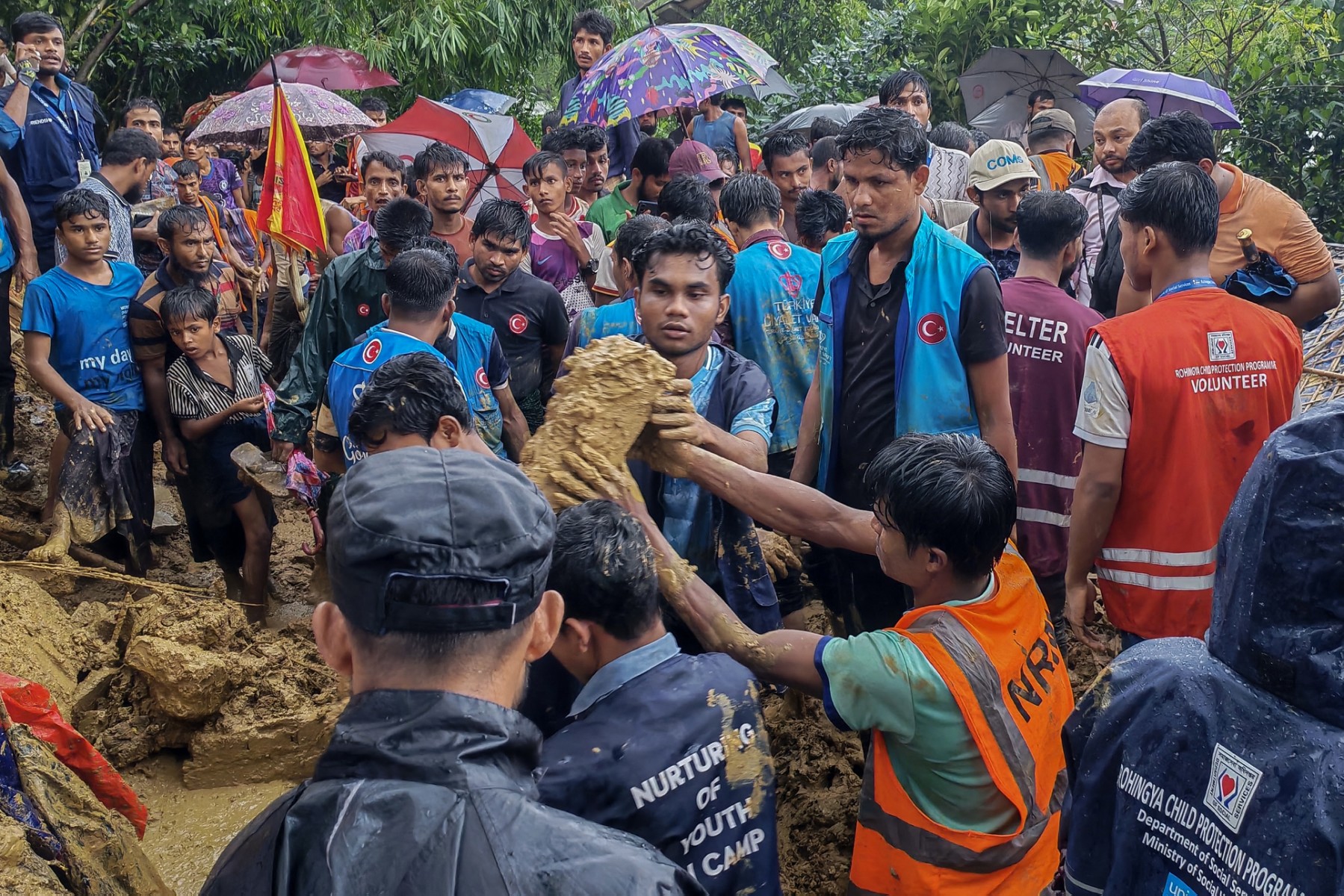 Bangladesh rescue personnel and volunteers work at the site of a landslide triggered by heavy rains at a school in the Kutupalong refugee camp in Cox’s Bazar on July 8 (Photo: STR / AFP)