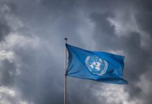 A United Nations flag waves under a cloudy sky at the UN offices in Geneva (Photo: Fabrice Coffrini / AFP)