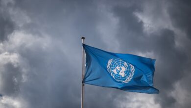 A United Nations flag waves under a cloudy sky at the UN offices in Geneva (Photo: Fabrice Coffrini / AFP)