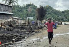 A man walks past the ruins of buildings after a junta airstrike in Kyauktaw, western Rakhine State, on June 18 (Photo: AFP)