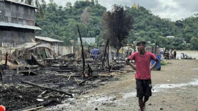 A man walks past the ruins of buildings after a junta airstrike in Kyauktaw, western Rakhine State, on June 18 (Photo: AFP)