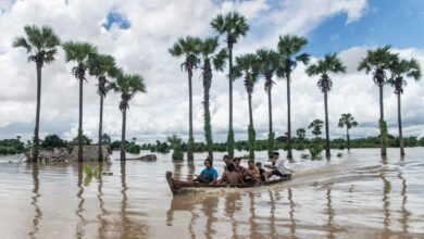 Locals use boats to travel through an area inundated by heavy rains and rising river waters in Wetlet Township, Sagaing Region, on August 10 (Photo: AFP)