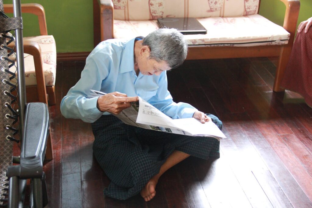My grandfather in 2013, reading a privately owned newspaper (Photo: Myo Thant) 