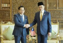 Myanmar junta leader Min Aung Hlaing, left, shakes hands with Malaysia’s Prime Minister Anwar Ibrahim in Putrajaya, Malaysia, on October 8 (Photo: AFP)