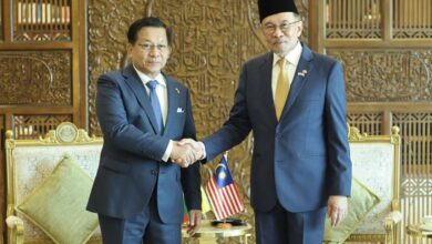 Myanmar junta leader Min Aung Hlaing, left, shakes hands with Malaysia’s Prime Minister Anwar Ibrahim in Putrajaya, Malaysia, on October 8 (Photo: AFP)