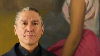 Kim Aris stands in front of a painting of his mother Aung San Suu Kyi in his London home (Photo: Supplied)