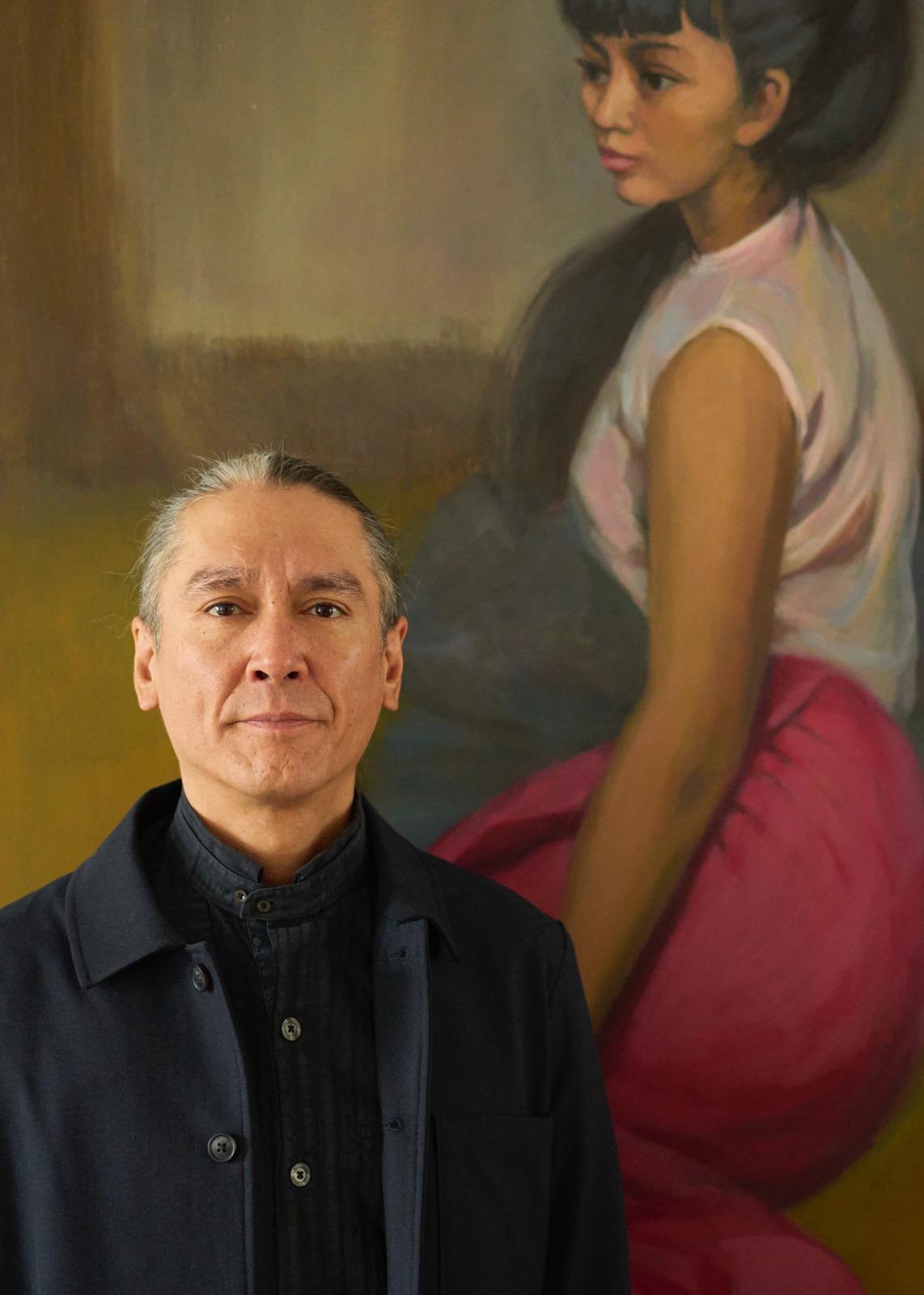 Kim Aris stands in front of a painting of his mother Aung San Suu Kyi in his London home (Photo: Supplied)