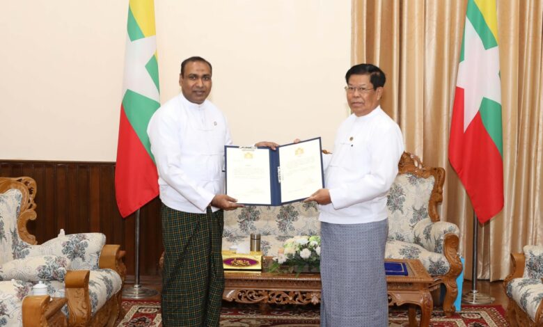 စစ်ကော်မရှင် နိုင်ငံခြားရေးဝန်ကြီး ဦးသန်းဆွေ (ယာ) က အိုက်စလန်နိုင်ငံ၏ ဂုဏ်ထူးဆောင်ကောင်စစ်ဝန် ခန့်အပ်လွှာကို ဦးကိုကိုလတ် (ဝဲဘက်) အား ပေးနေသည်ကို ဖေဖော်ဝါရီလ ၂၃ ရက်နေ့တွင် ထုတ်ပြန်ထားစဉ် ။ (ဓာတ်ပုံ - MOFA)